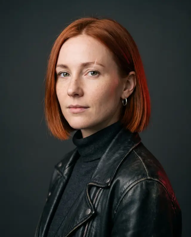 Reference portrait of a fictional woman with a copper bob and a scar through her eyebrow